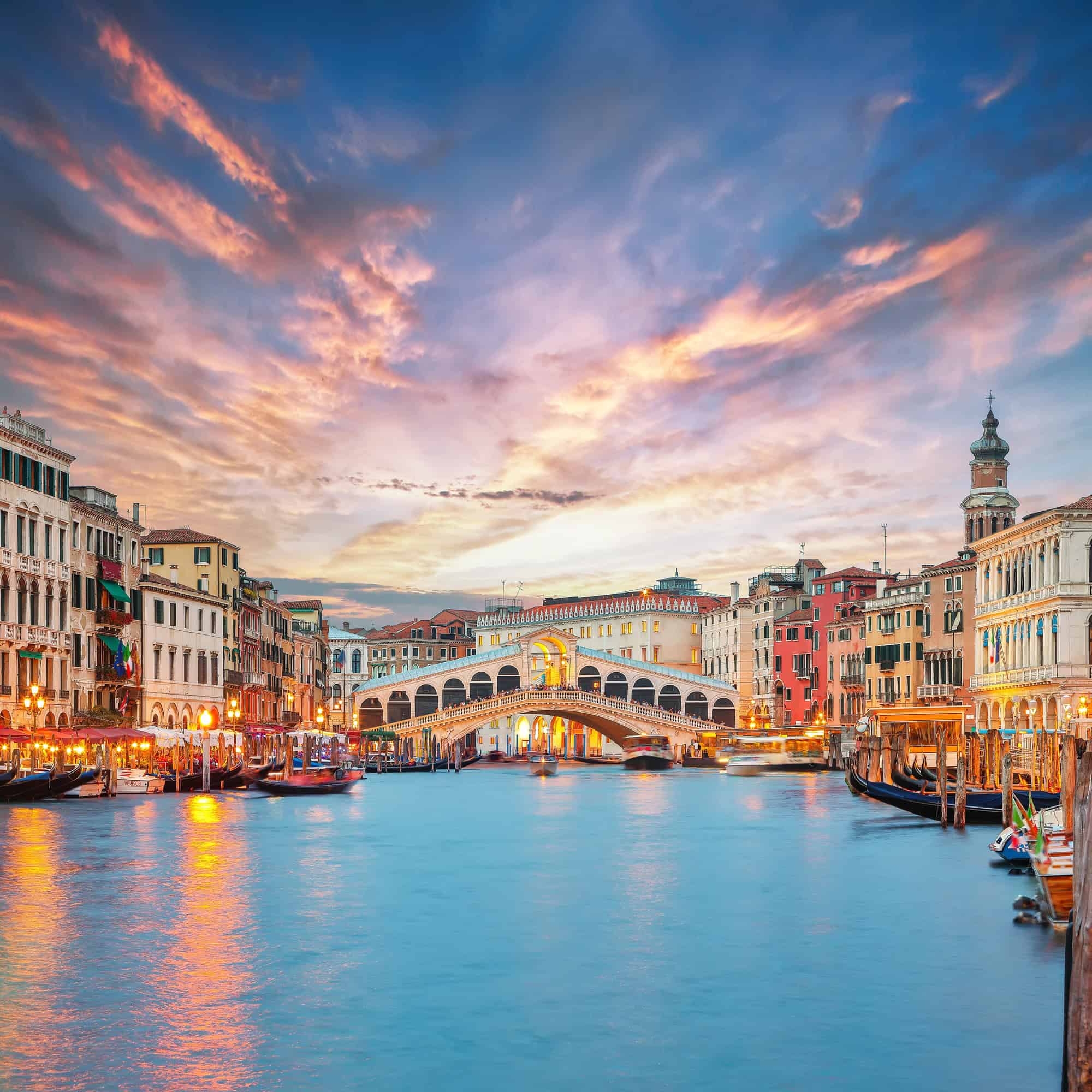 Amazing sunset and evening cityscape of Venice with famous Canal Grande and Rialto Bridge