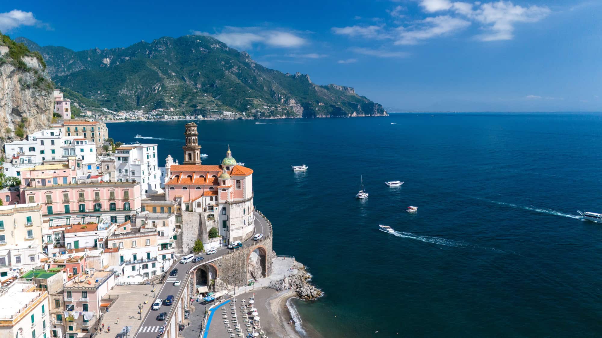 Breathtaking view of Amalfi Coast showcasing charming seaside village on a bright sunny day