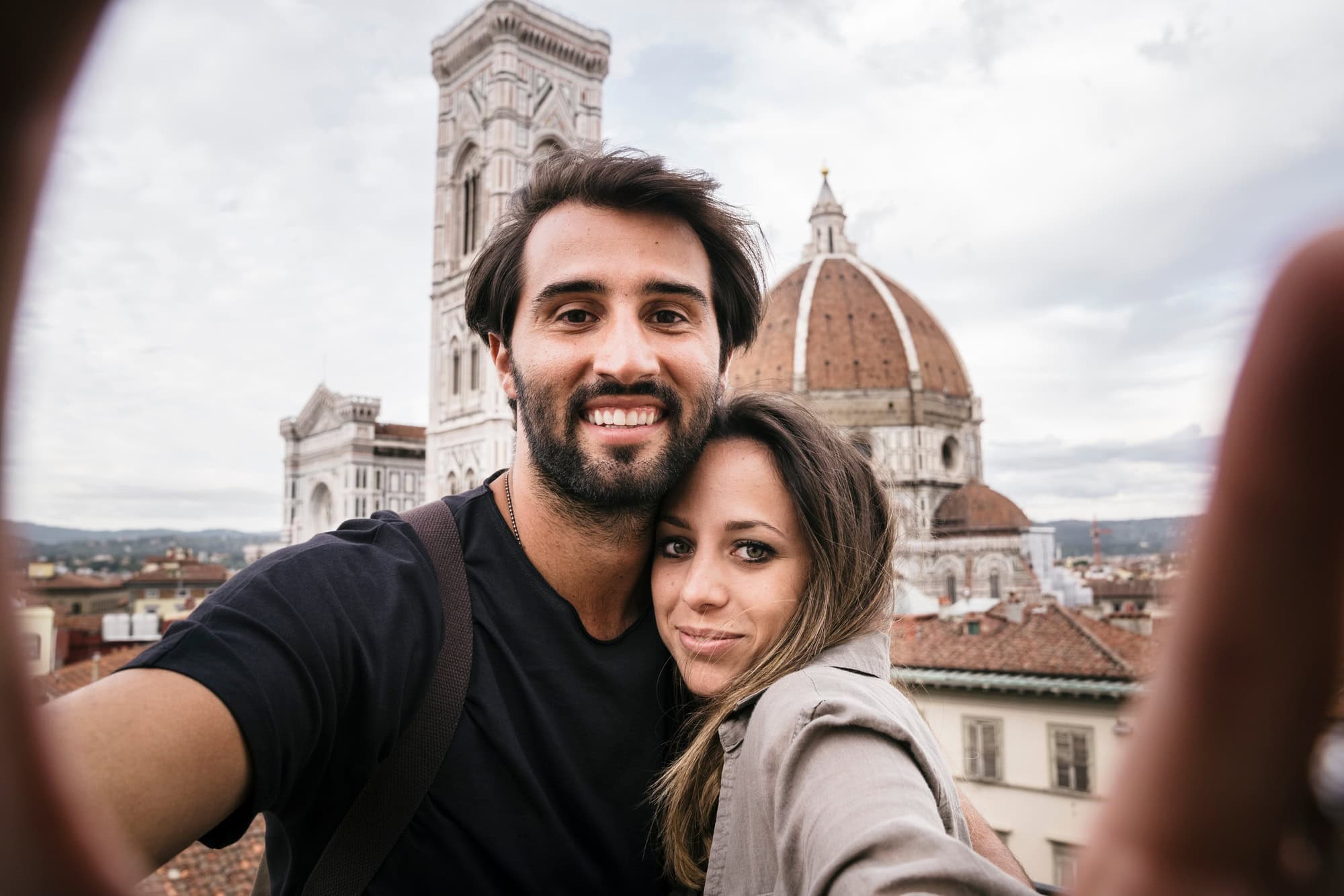 Couple in love visiting Florence Italy and taking a selfie with a smartphone