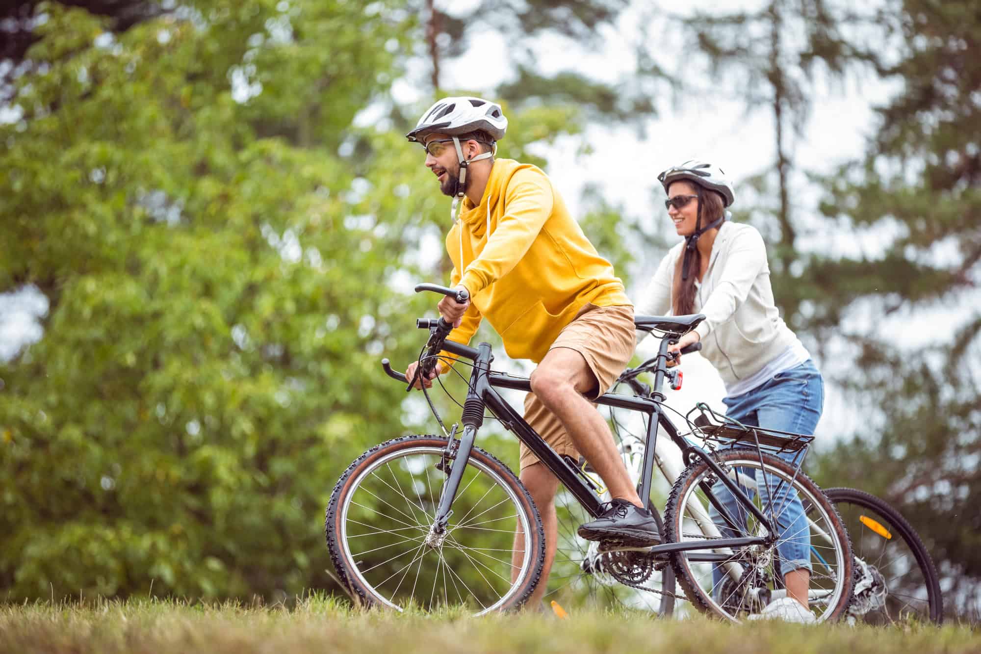Happy couple on a bike ride in the countryside